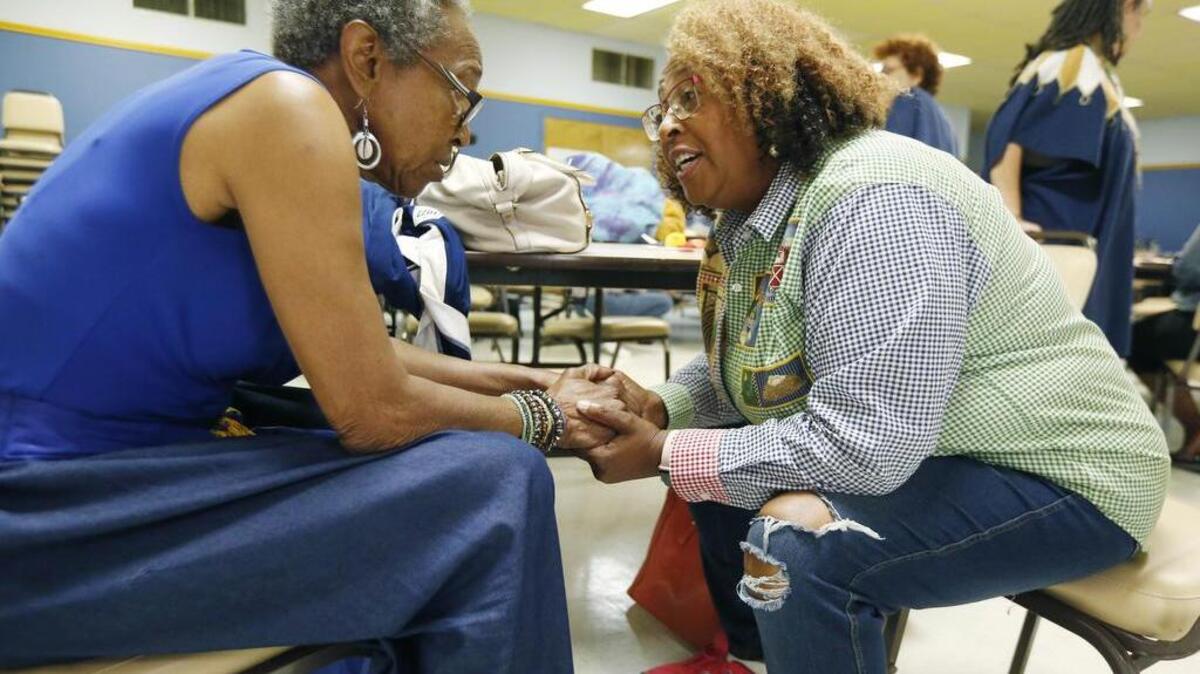 Cindy Ayers, CEO of Foot Print Farms, right, confers with her friend Imalika Adams Johnson, a veteran of the civil rights movement, at a forum in Jackson, Miss., in August of several Mississippi grassroots political organizations with the Black Voters Matter Fund.