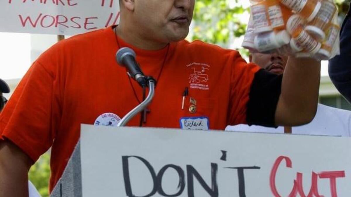 In 2004, in one of the many attempts over the decades to fix the workers comp system, Richard Perez held up a bag of medications he has been prescribed as he joined others protesting the proposed new laws to workers comp claims outside the Capitol.