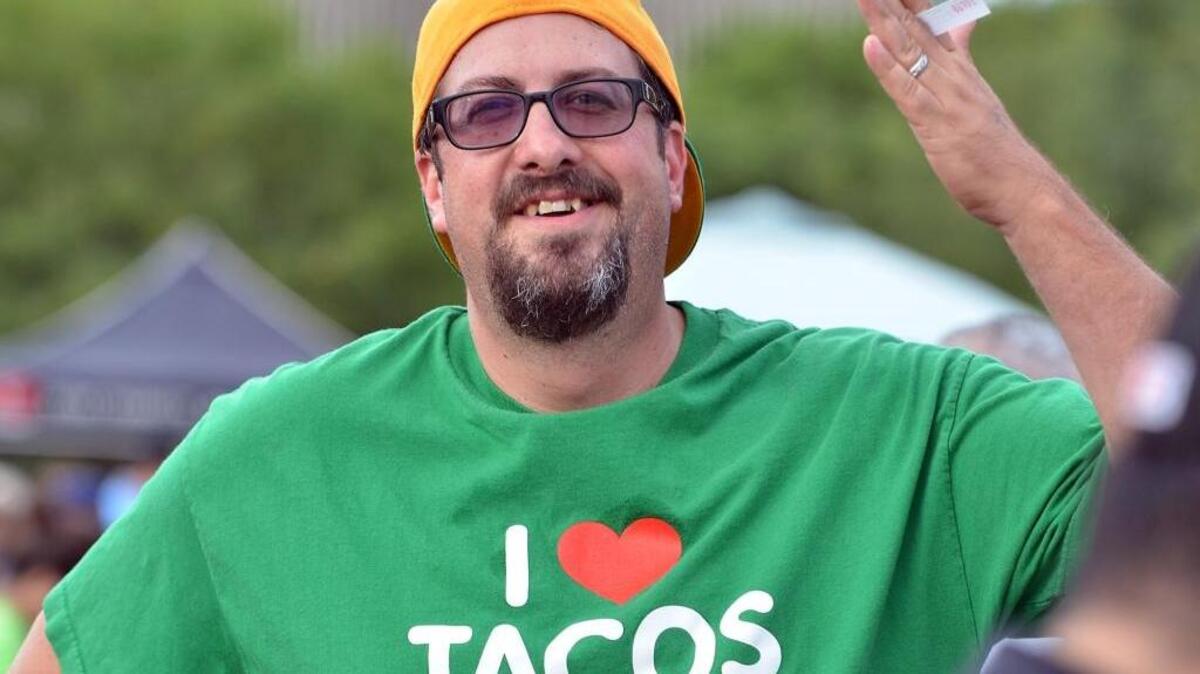 David Barr waits in line for his tacos at Taco Throwdown before a Fresno Grizzlies game in August.