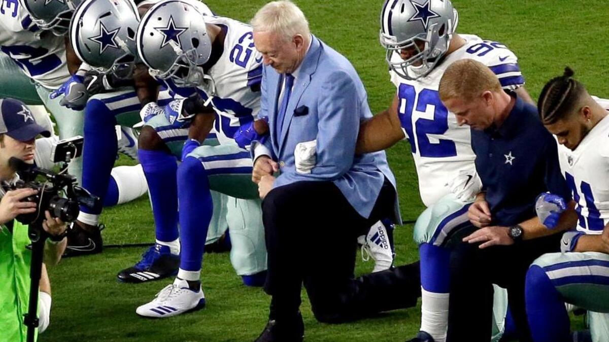 Dallas Cowboys, led by owner Jerry Jones, take a knee prior to the national anthem prior to an NFL football game against the Arizona Cardinals.