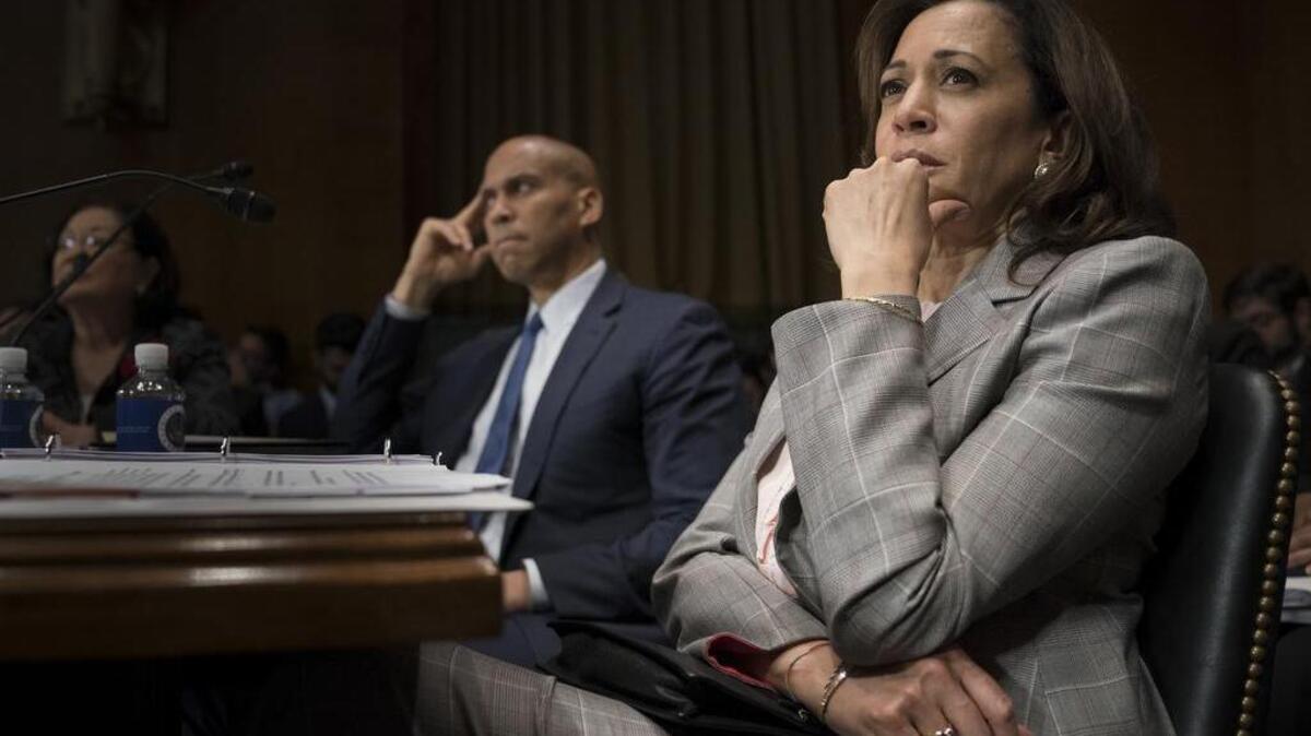 Sens. Kamala Harris, D-Calif., and Cory Booker, D-N.J., listen to remarks Thursday at the Senate Judiciary Committee where they considered the nomination of Judge Brett Kavanaugh to the U.S. Supreme Court.