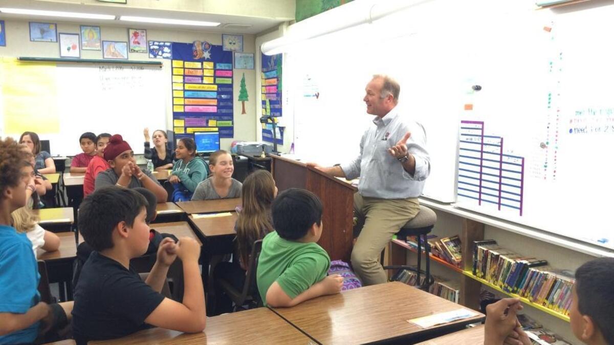 Coach Tim DeRuyter speaks to a fifth-grade class at Gettysburg Elementary School in Clovis for Read Across America Day last month. Clovis Unified is the biggest school district in California without a teachers union.