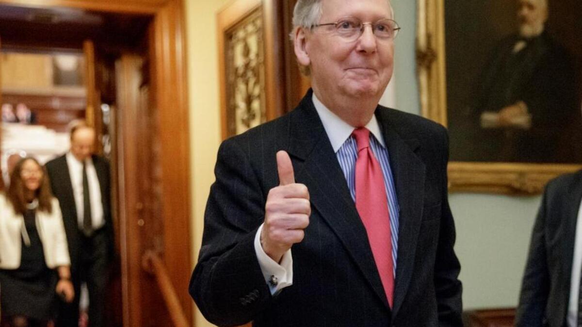 Senate Majority Leader Mitch McConnell of Kentucky signals a thumbs-up as he leaves the Senate chamber Thursday, after he led the GOP majority to change Senate rules and lower the vote threshold for Supreme Court nominees from 60 votes to a simple majority in order to advance Neil Gorsuch to a confirmation vote.