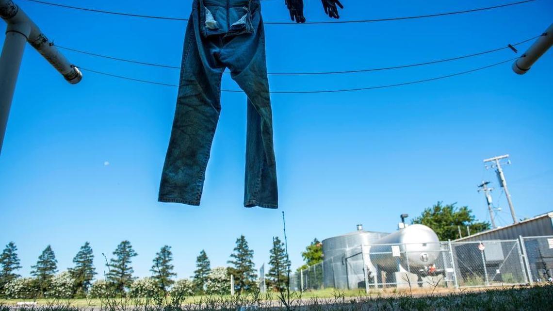 A pair of work pants and gloves air dry at the Davis Migrant Center in Dixon on Thursday, July 13, 2017. An outdated state regulation has for years forced migrant families into a choice of bad options: Lose housing, uproot children before the end of the school year, or leave children behind to finish school while parents move on.