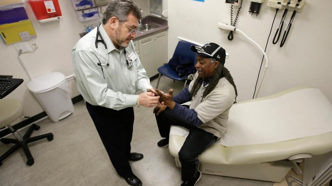 Leonid Basovich, left, examines Medi-Cal patient Michael Epps at the WellSpace Clinic in Sacramento in February.