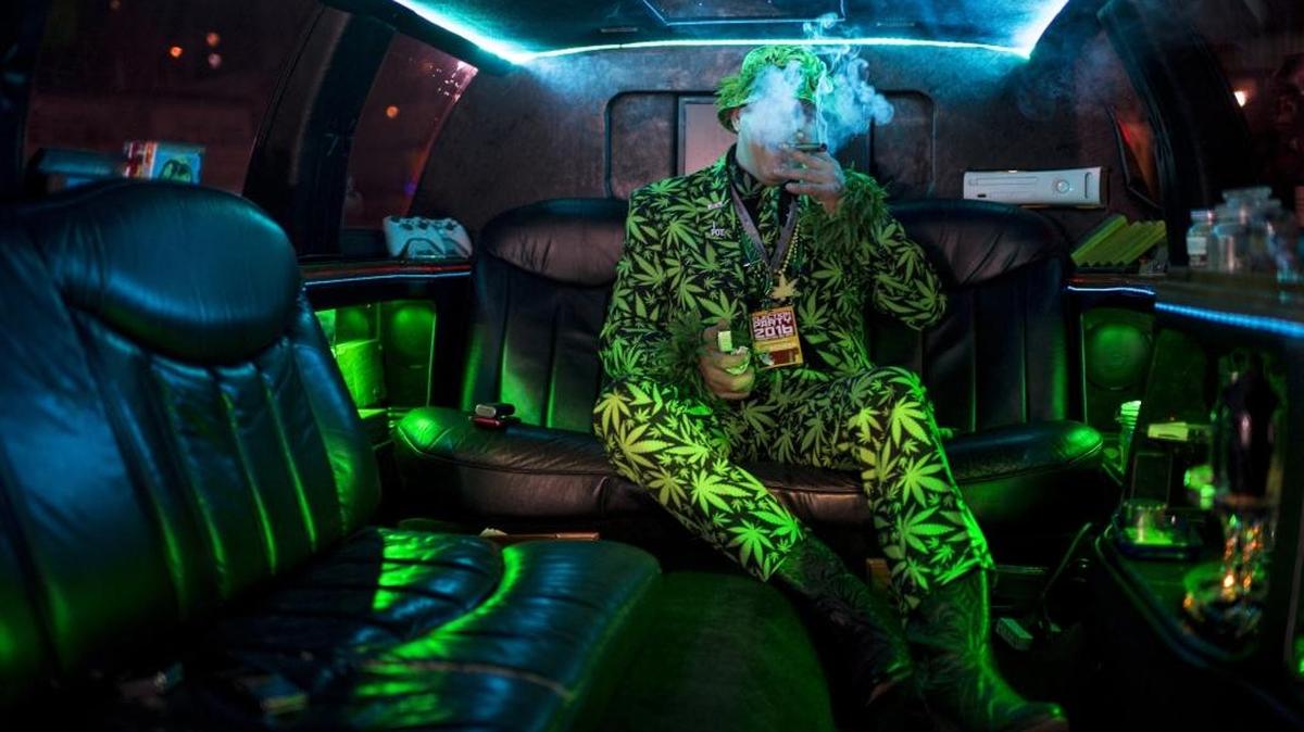 Mike “Big Mike” Barnes takes a celebratory puff from his pipe in his privately owned “420 Limo” at an election party hosted by the Berkeley Patients Group for Proposition 64, which legalized and taxes the recreational use of marijuana, at The New Parish club on Tuesday, Nov. 8. 2016, in Oakland, Calif.
