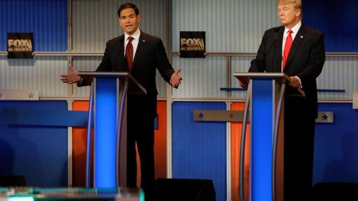 Marco Rubio, left, makes a point as Donald Trump listens during the Republican presidential debate in Milwaukee on Tuesday. Few candidates said much about the working class.