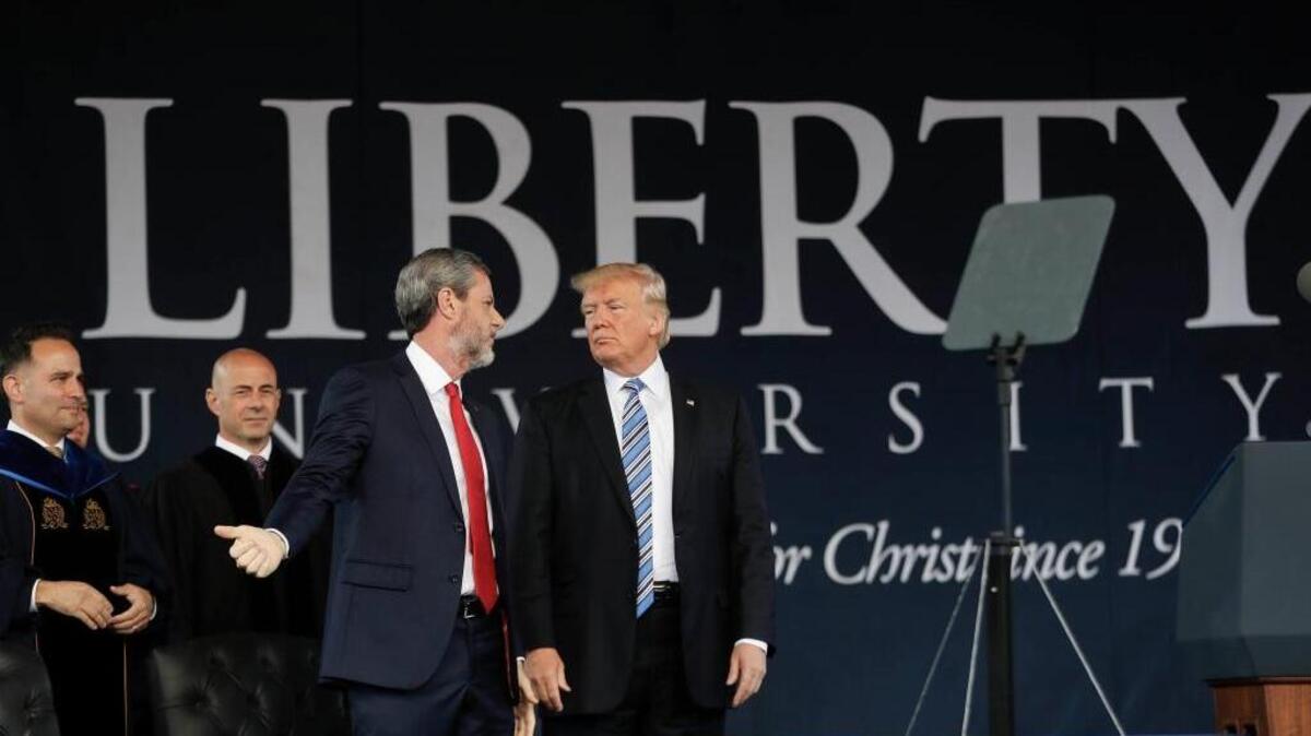 After giving the commencement address for the Class of 2017 at Liberty University in Lynchburg, Va., on Saturday, President Donald Trump speaks with Liberty University President Jerry Falwell Jr.