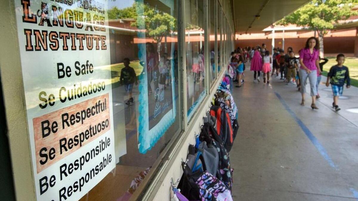 Bilingual signs line the hallway at Thomas Edison Language Institute in Carmichael in September. The institute has taught students in both Spanish and English for years, and the passage of Proposition 58 gives schools more freedom on bilingual education.