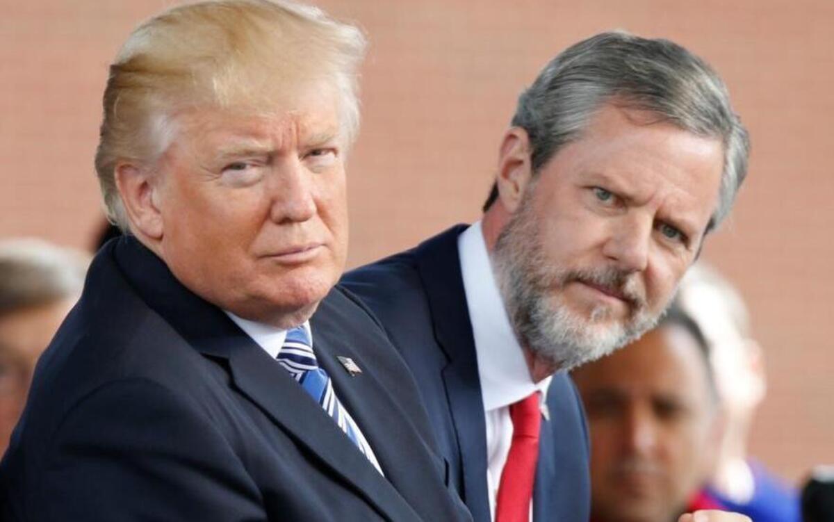 President Donald Trump, left, and Liberty University President Jerry Falwell Jr. listen to music during commencement ceremonies at the school in Lynchburg, Va., in May 13, 2017.