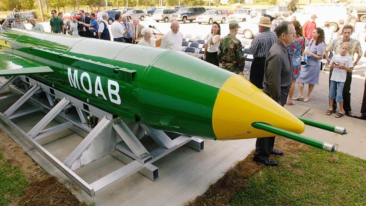 A group gathers around a GBU-43B, or massive ordnance air blast (MOAB) weapon, on display at the Air Force Armament Museum on Eglin Air Force Base near Valparaiso, Fla. U.S. forces in Afghanistan struck an Islamic State tunnel complex in eastern Afghanistan on April 13.