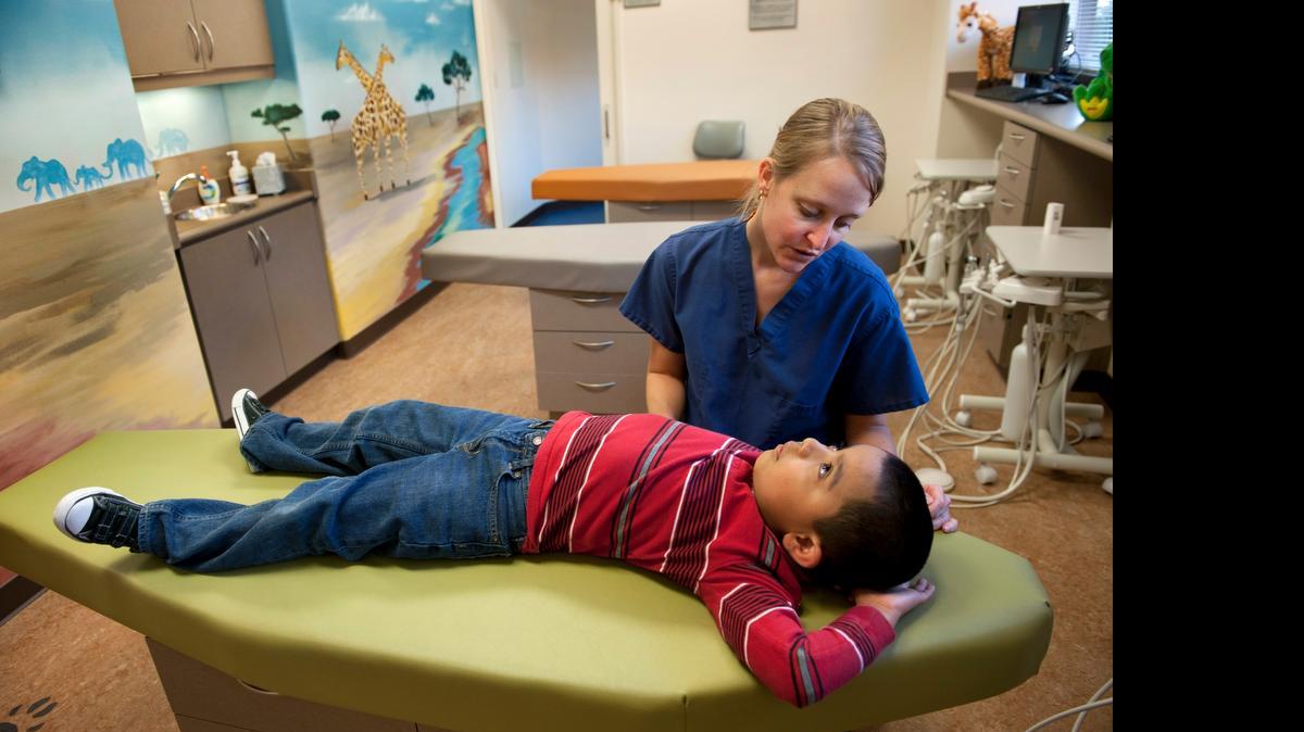 
Michelle Kucera talks with her patient Jesus Rojas Jimenez at the Effort Oak Park dental clinic, where a vast majority of kids are on Denti-Cal.
