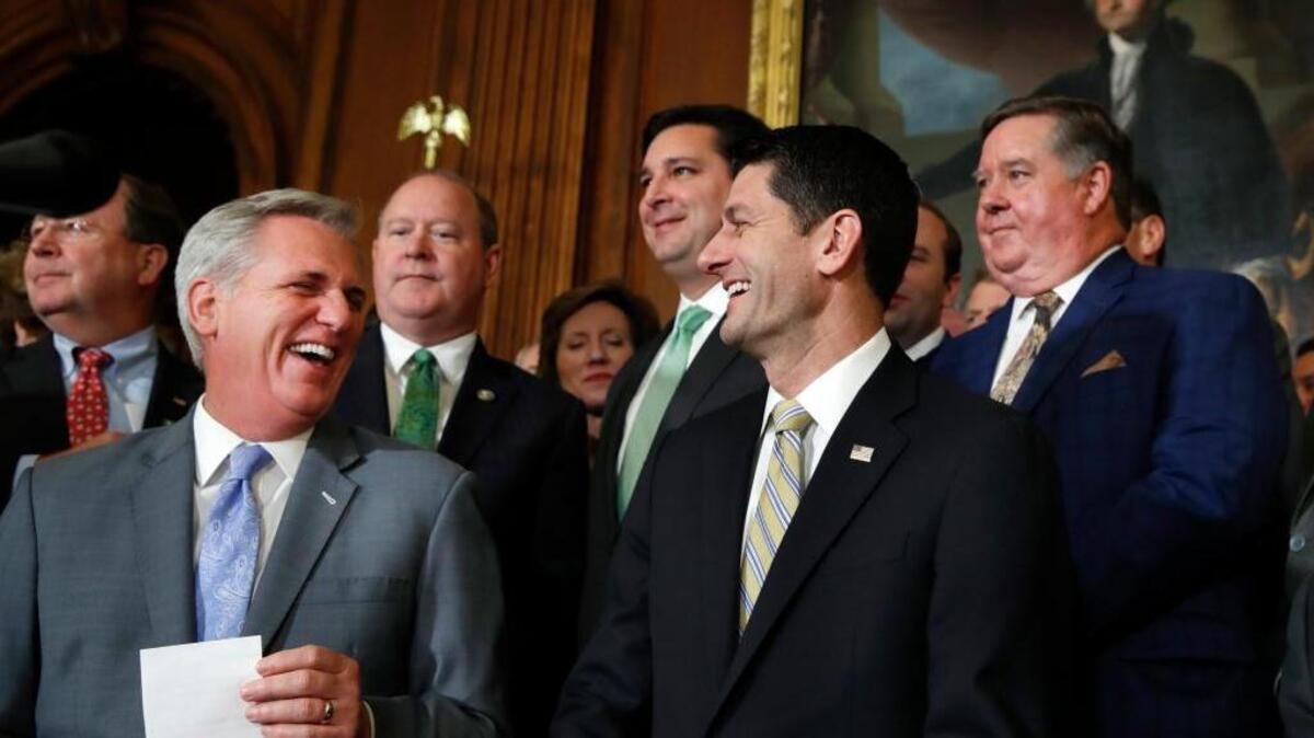 House Majority Leader Kevin McCarthy of California and House Speaker Paul Ryan of Wisconsin smile as they talk with reporters after the GOP tax overhaul bill passed in the House on Nov. 16.