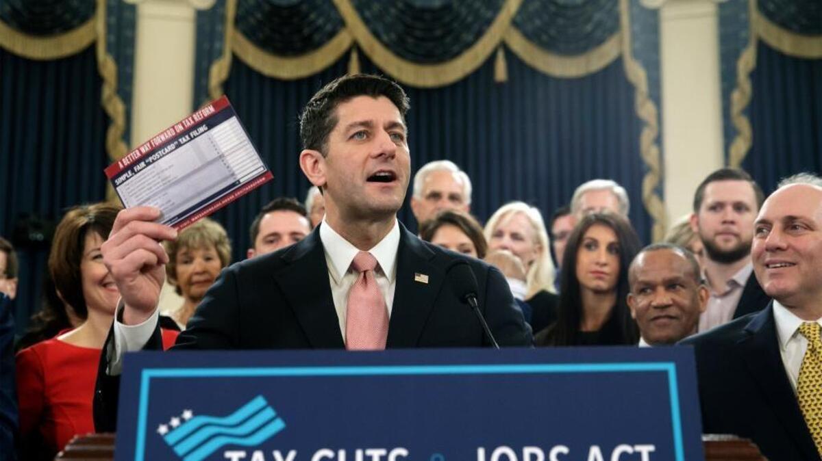 House Speaker Paul Ryan of Wisconsin holds a proposed “postcard tax filing form” as Republicans unveil a tax overhaul plan on Nov. 2.