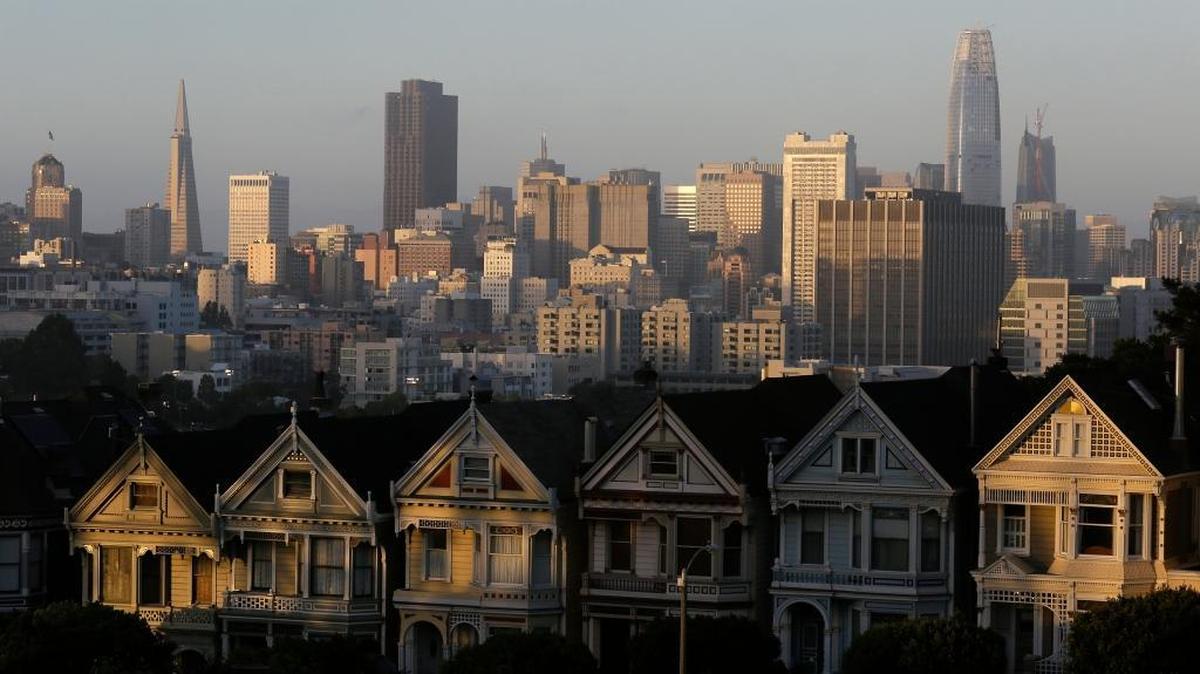 The Salesforce Tower, at right, is seen along the skyline beyond Victorian homes in San Francisco in July.