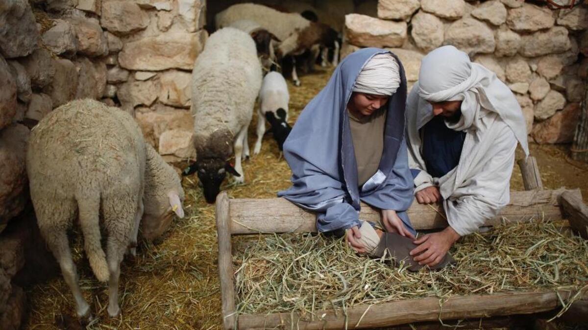 Christian actors portray Joseph and Mary during a re-enactment of a Nativity scene of the birth of Jesus Christ during Christmas festivities at the Nazareth Village in Nazareth, northern Israel, Thursday, Dec. 21, 2017.