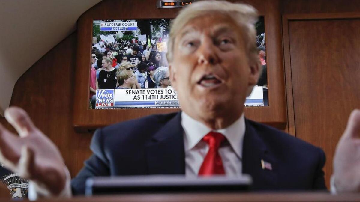 President Donald Trump watches the Senate vote on his Supreme Court nominee Brett Kavanaugh while on board Air Force One on Saturday.