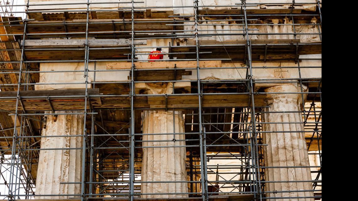 A man works at the Parthenon on Acropolis Hill in Athens, Greece, on Wednesday.