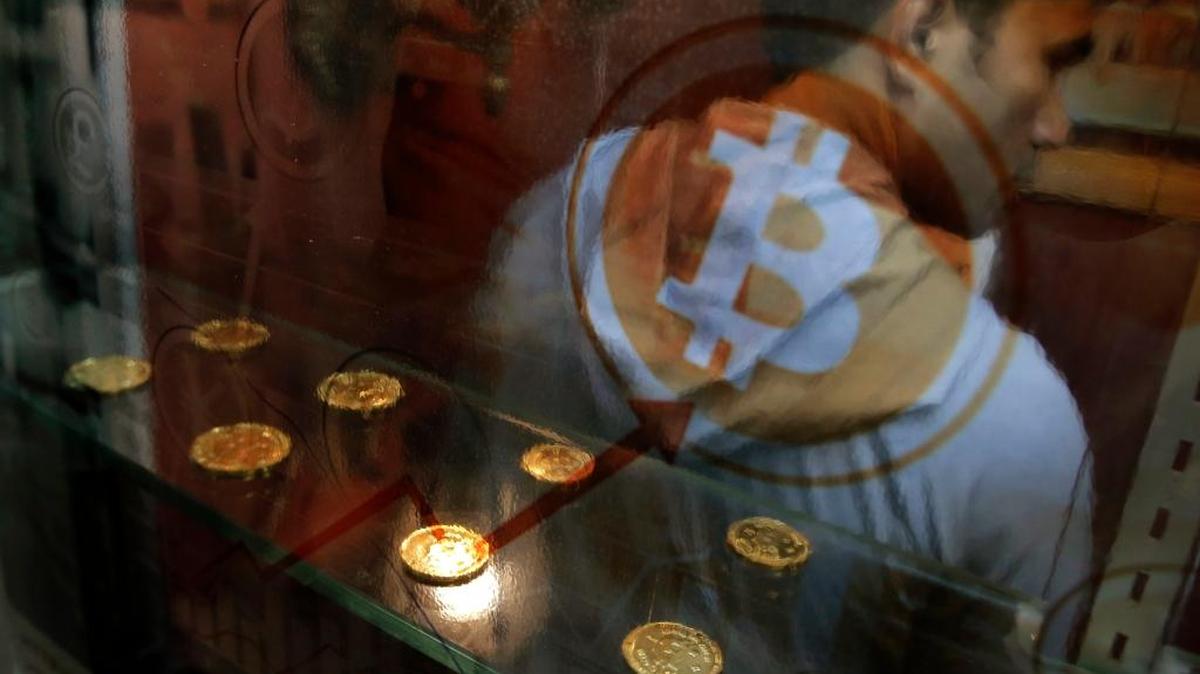 A man uses a bitcoin ATM in Hong Kong on Dec. 8.