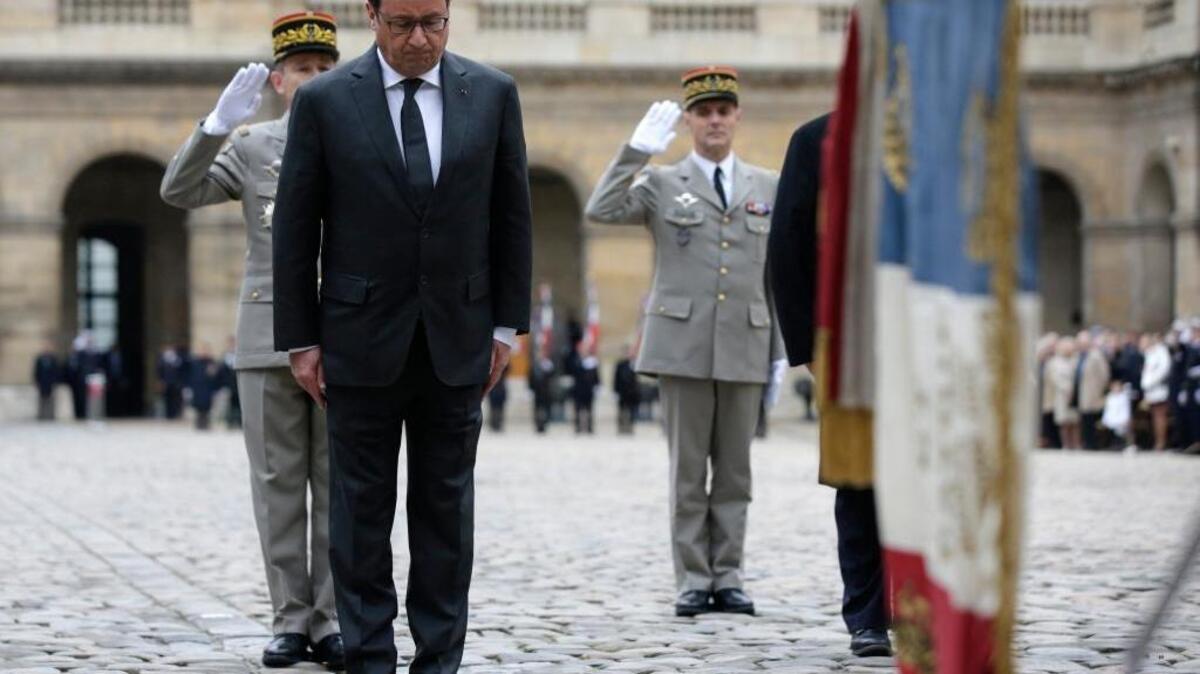 French President Francois Hollande attends a military ceremony in the courtyard of the Hotel National des Invalides in Paris on Thursday. He has declared the Paris terror attacks an act of war and sent planes to bomb Syria.
