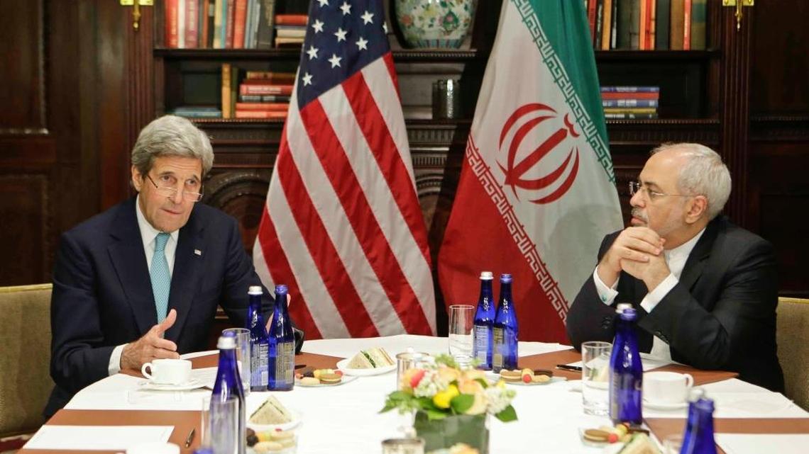 Then-Secretary of State John Kerry speaks to the media as Iranian Foreign Minister Mohammad Javad Zarif listens in New York in April 2016.
