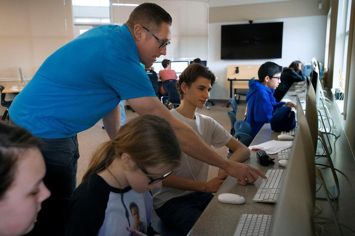 Computer tech teacher Jeff Darrow assists students at Winston Churchill Middle School in Carmichael in 2016. The school was recognized among the 2026 California Distinguished Schools.