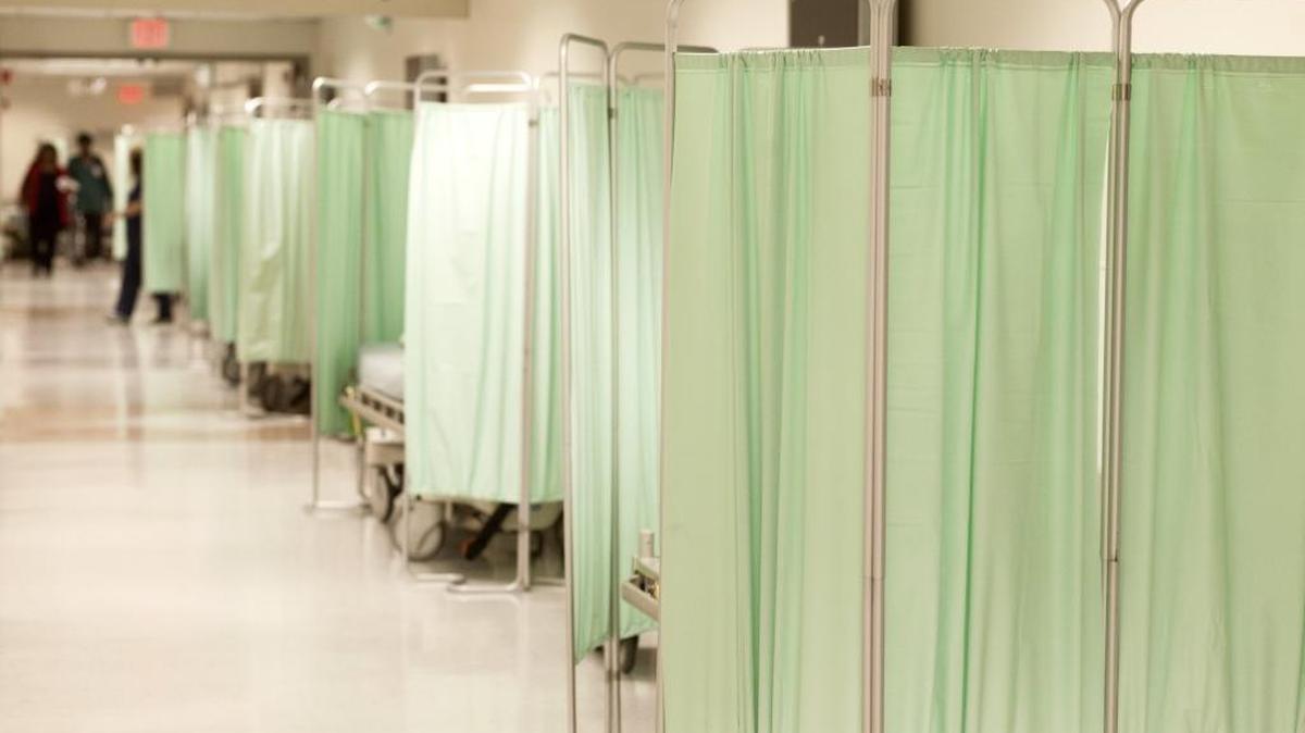 Additional beds are set up in the hallway of an emergency room, which in California and other states are being crowded by an influx of mental health patients.