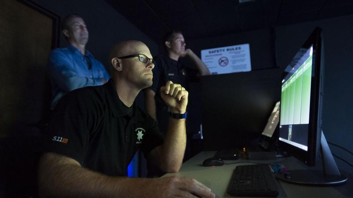 Sacramento police training Officer Dustin Smith, center, monitors a simulation exercise at the Police Academy in August.