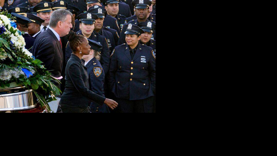 
New York Mayor Bill de Blasio and his wife, Chirlane McCray, arrive for the funeral of NYPD Officer Rafael Ramos on Saturday. Ramos and his partner, Wenjian Liu, were killed Dec. 20 as they sat in their patrol car. 
