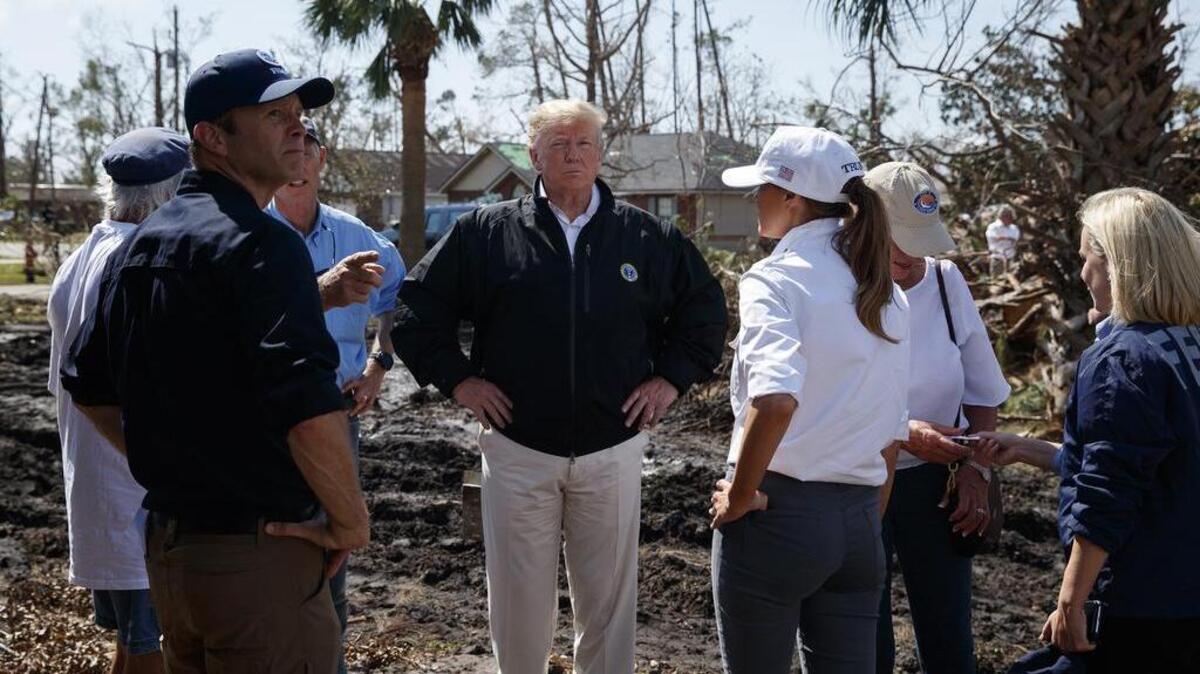 President Donald Trump and first lady Melania Trump tour a neighborhood affected by Hurricane Michael on Monday in Lynn Haven, Fla.