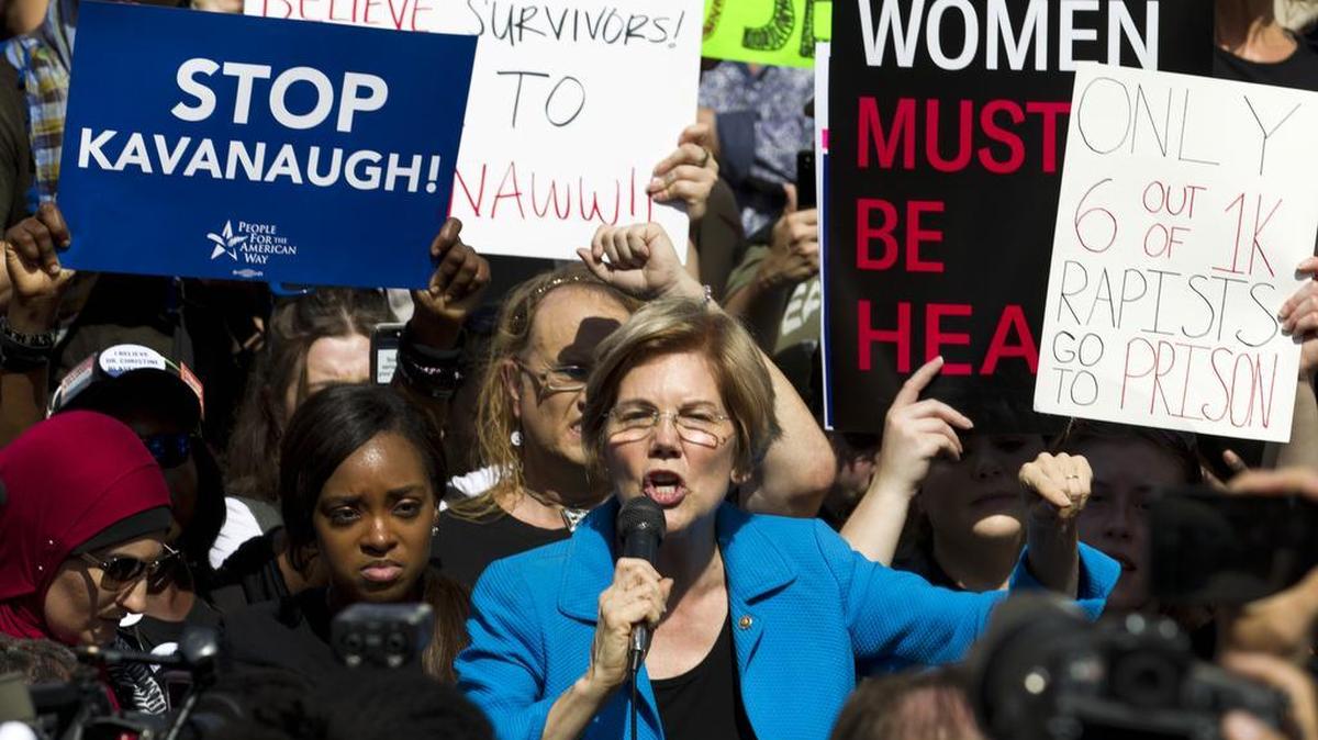 Sen. Elizabeth Warren, D-Mass., speaks to demonstrators as they protest against Supreme Court nominee Brett Kavanaugh outside the U.S. Capitol on Oct. 4.