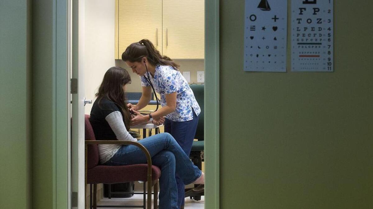 
Patient Faith Hidalgo, 12, of Meadow Vista, left, is examined by Medical Assistant Madeline Cardona at the Weimar Institute in Weimar on April 3, 2015.
