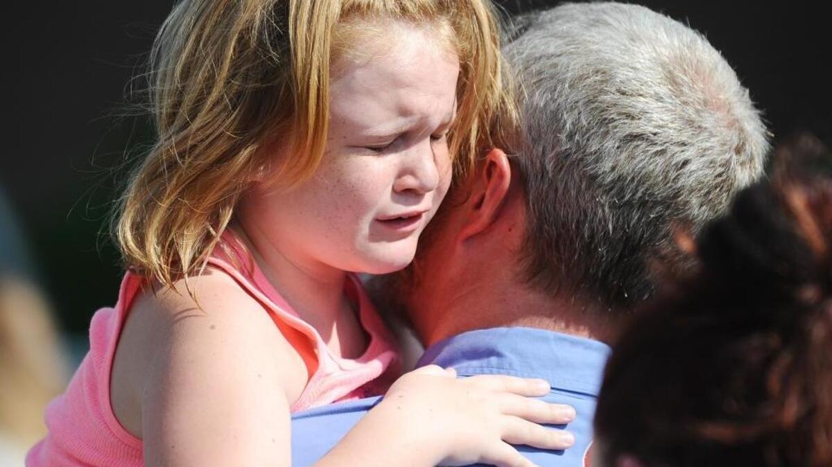 Lilly Chapman, 8, cries after being reunited with her father, John, after a shooting Sept. 28 at Townville Elementary School in Townville, S.C.