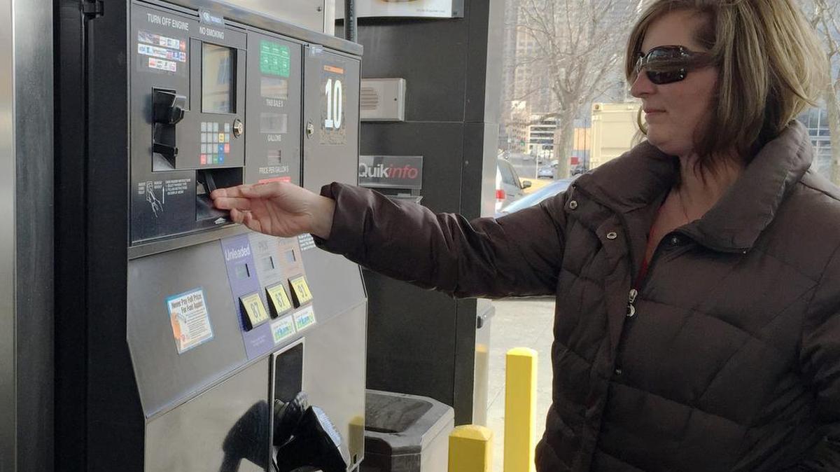 A customer waits for a receipt at a gas station in Des Moines in February 2015 on the day the Iowa Senate approved a 10-cent increase to the state fuel tax to help pay for road improvements.