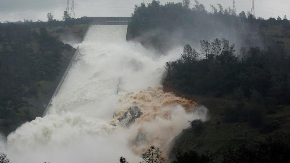 Water flows through break in the wall of the Oroville Dam spillway during heavy rains on Thursday, Feb. 9, 2017. The threat of a major flood is an ongoing risk in the Central Valley, and especially in Sacramento, much of which is situated on a flood plain. (AP Photo/Rich Pedroncelli)