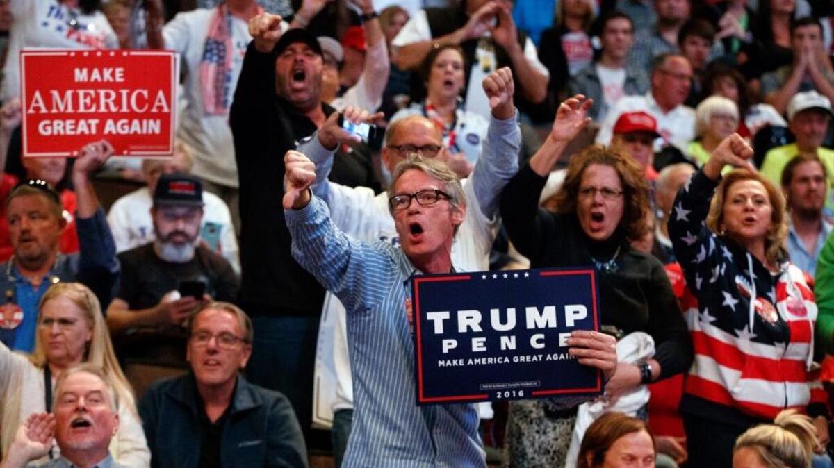 Supporters of Republican presidential candidate Donald Trump yell at reporters as they arrive for a campaign rally Thursday in Cincinnati.