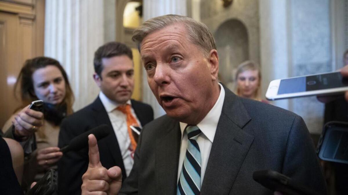 Sen. Lindsey Graham, R-S.C., a member of the Senate Judiciary Committee, makes an emphatic point to reporters about Brett Kavanaugh’s accusers at the U.S. Capitol on Wednesday.