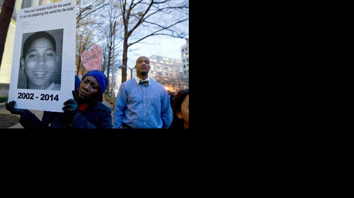  Tomiko Shine holds up a picture of Tamir Rice, the   boy fatally shot on Nov. 22 by a police officer in Cleveland.   Rice’s death has   sparked community demonstrations against police shootings.