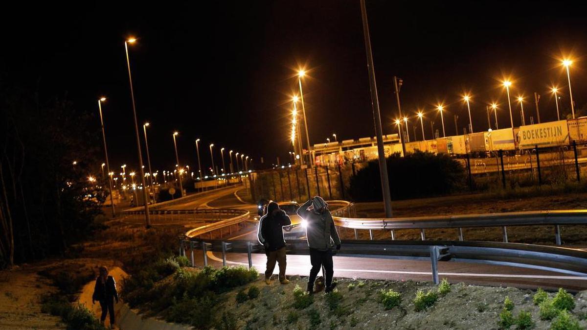 
Migrants walk on a road outside the Eurotunnel area, in Calais, northern France, last week. More than 3,000 migrants have tried to storm the area surrounding the Eurotunnel in an attempt to enter Britain. 
