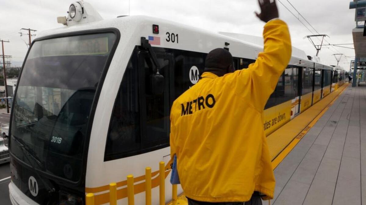 A conductor coordinates a preview ride of the 8.6-mile Metro Expo light-rail line in Los Angeles in 2012. The Expo Line will begin service to West Los Angeles and Santa Monica on May 20.