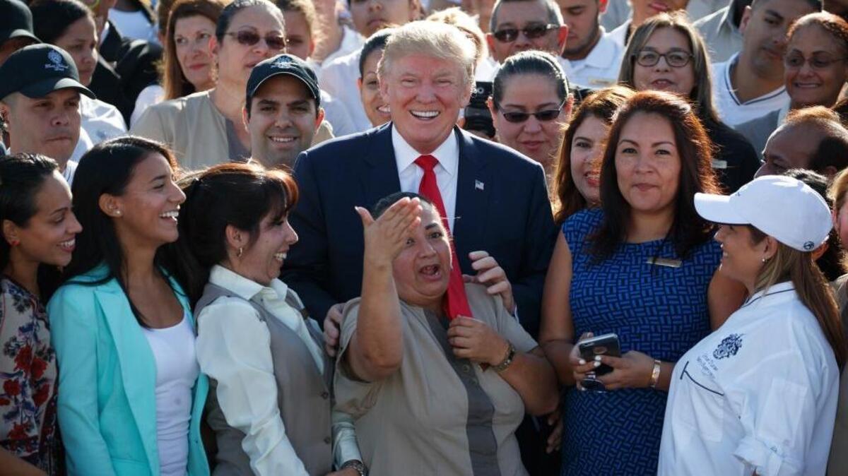 Donald Trump poses for photographs during an campaign event with employees at Trump National Doral in Miami on Tuesday.