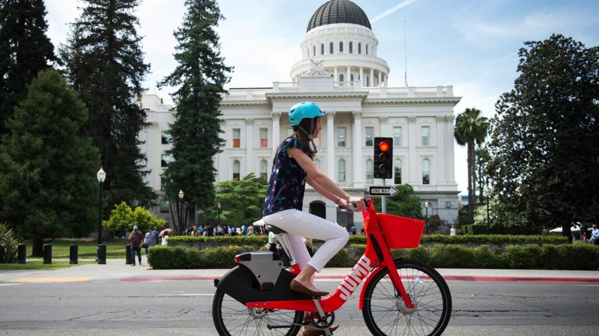 Chelsea Payne tries out one of the new Jump rental bikes available in Davis, Sacramento and West Sacramento. In West Sacramento, they are only one part of a new way to look at public transit.