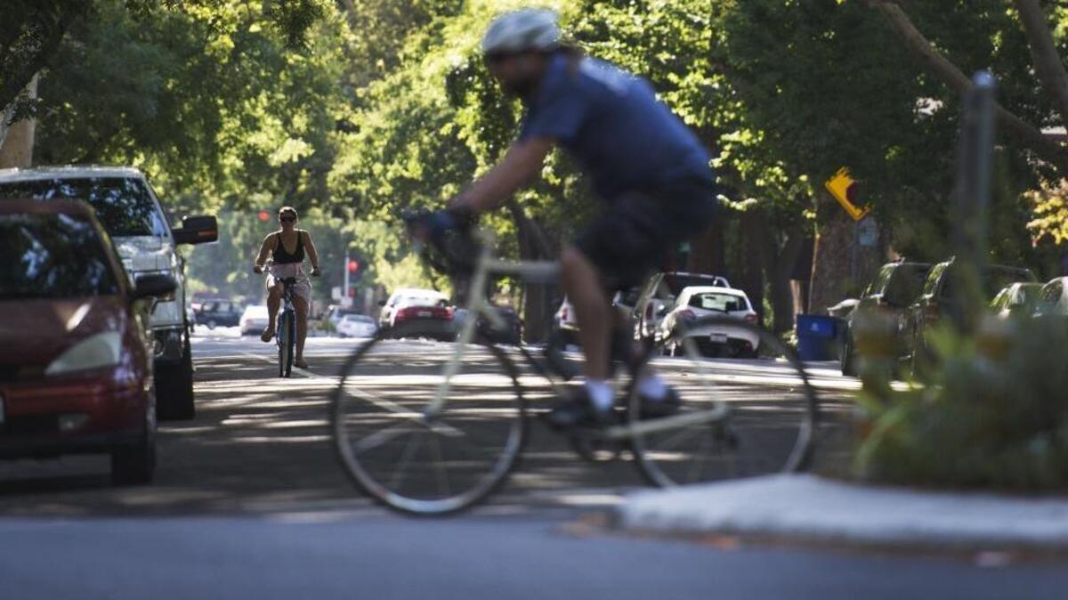 Bicyclists ride on 25th and G streets in midtown.