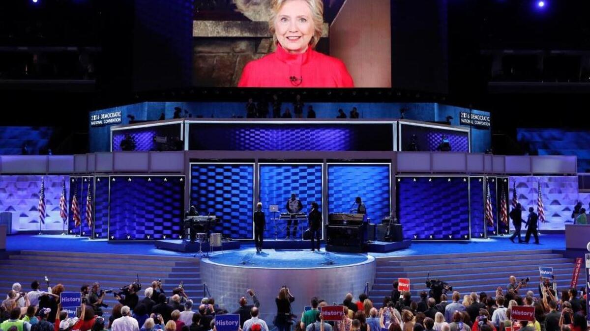 Hillary Clinton appears on a monitor to thank delegates for their support at the Democratic National Convention in Philadelphia. On Tuesday, she became the first woman to be nominated for president by a major party.