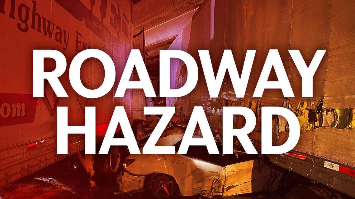 Roadway Hazard: An illustrative photo of a car crushed by two big rigs