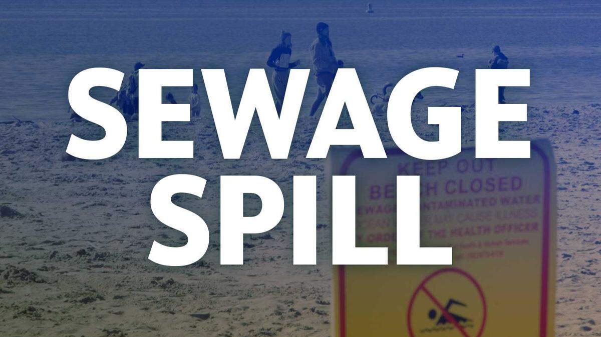 Sewage spill: A beach with a warning sign posted about a sewage spill.