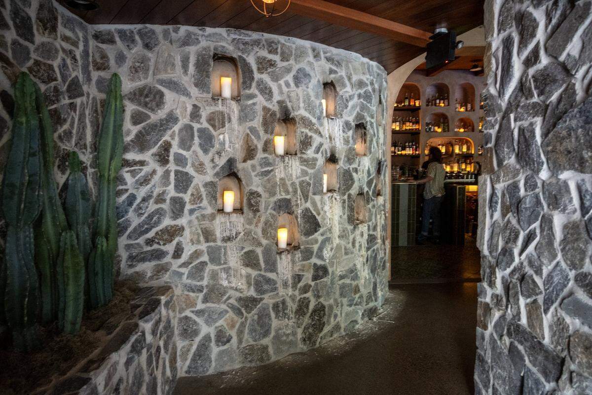 Stone walls with burning candles greet customers at the entrance to Day Tripper in midtown Sacramento on Wednesday, May 27, 2026.
