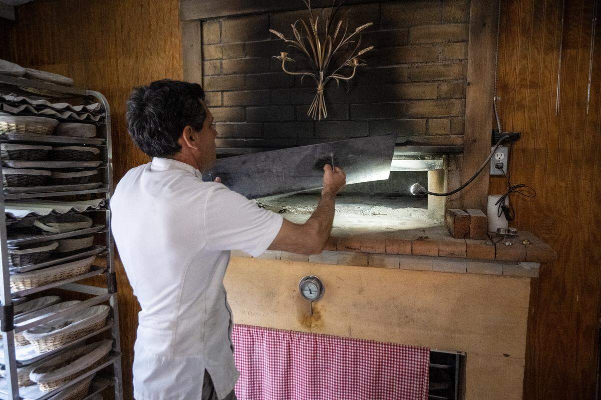 Dorian Matei, owner of Artisan Lavinia in Oregon House, bakes breads in a wood-fired oven on May 2.