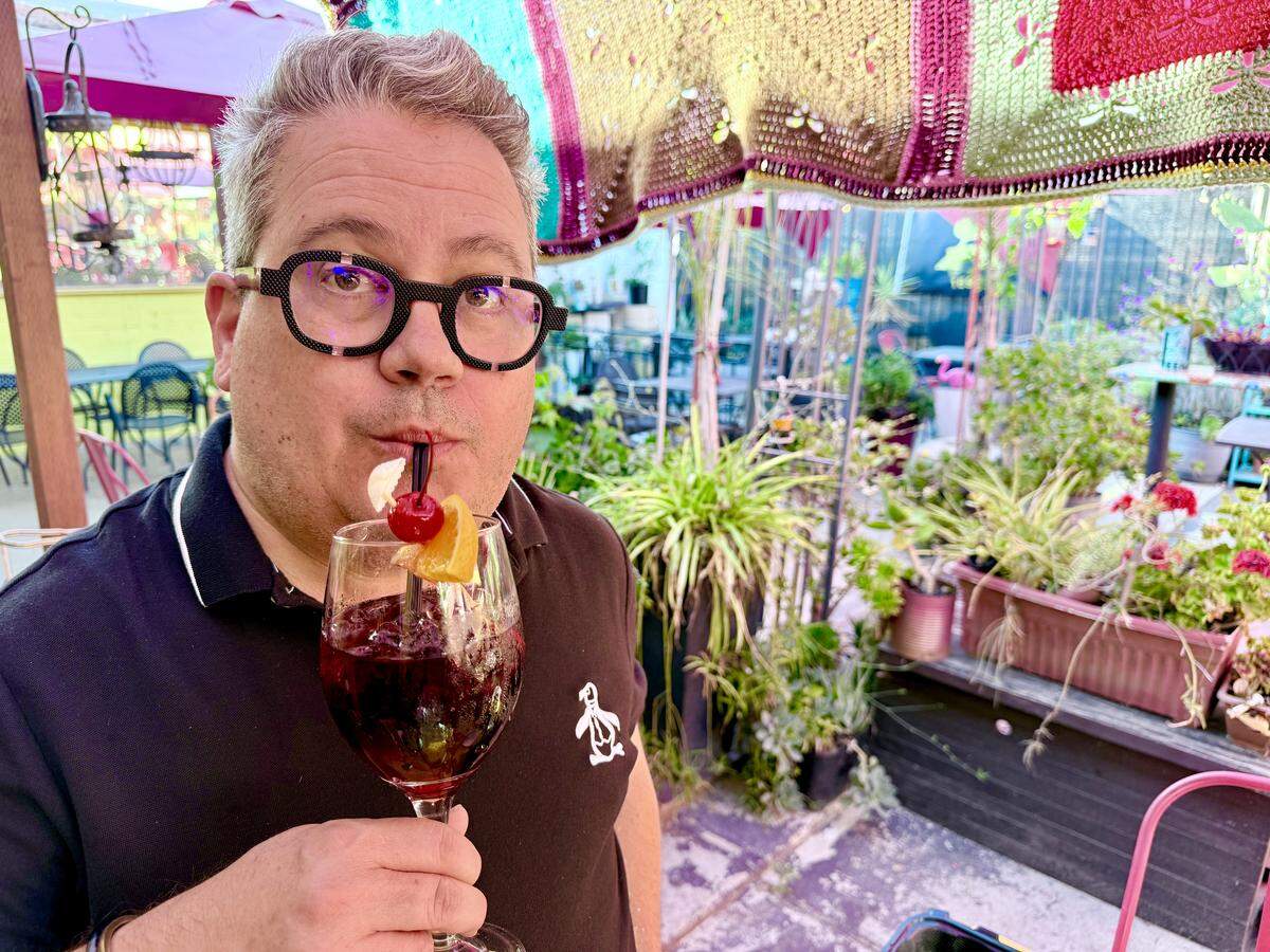 The Bee’s food & dining reporter, Sean Timberlake, enjoys a sip of sangria in the back patio at Lola’s Lounge at 2424 16th St., in Land Park on Wednesday, May 13, 2026.