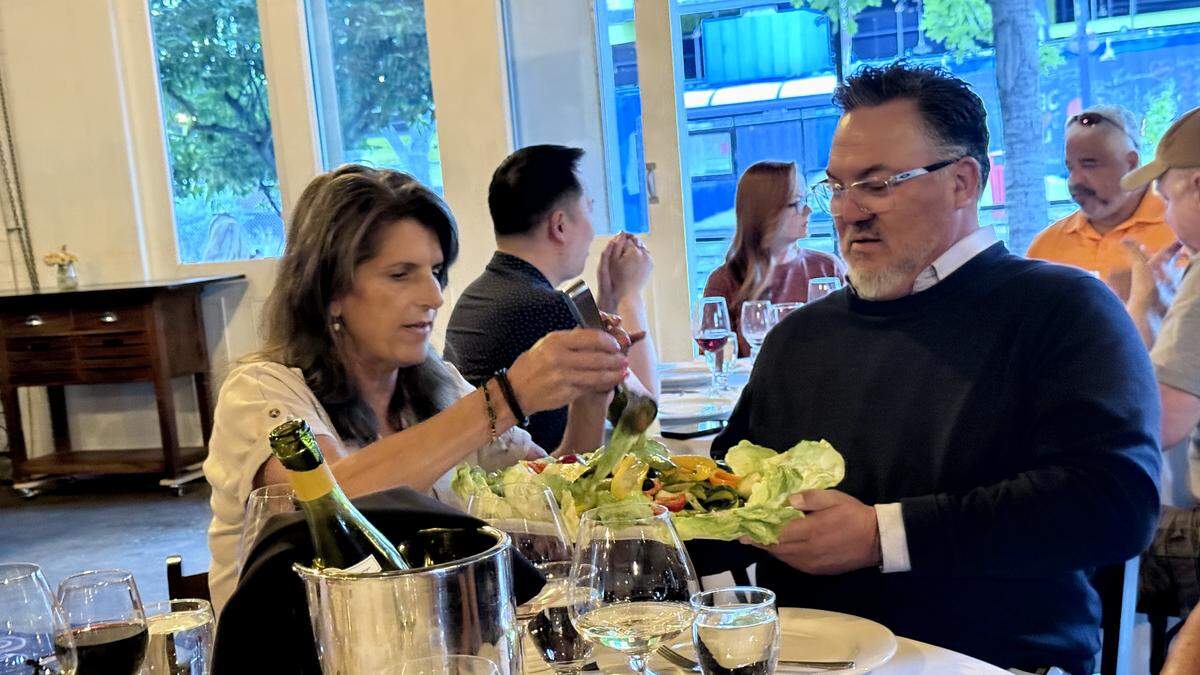 Tom Martinez, CEO of California Exposition & State Fair, holds up a platter of fresh vegetables tossed in bagna cauda dressing for Bobbin Mulvaney, co-owner of Mulvaney’s B&L at 1215 19th St. on Monday, May 18, 2026.
